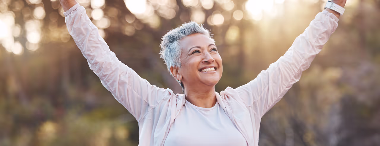 Eine ältere Frau strahlt, weil sie keine Rückenschmerzen mehr hat