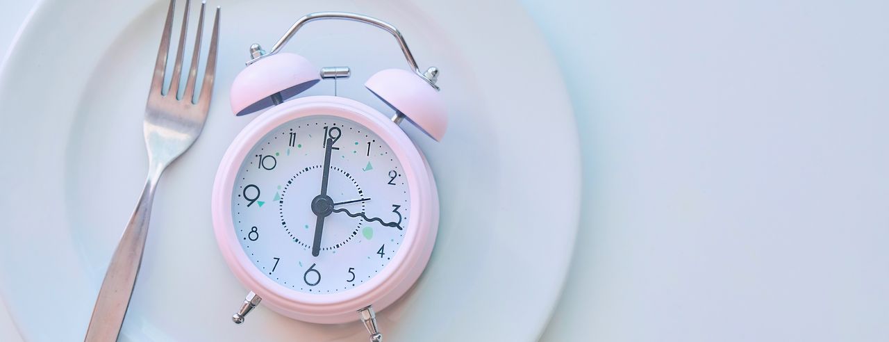 A plate with an alarm clock on it