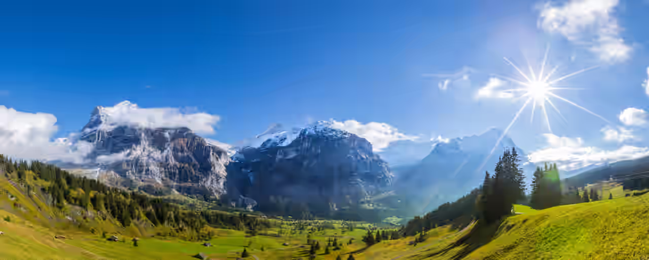 A fantastic mountain panorama glistens in the sunshine on a summer vacation in the mountains