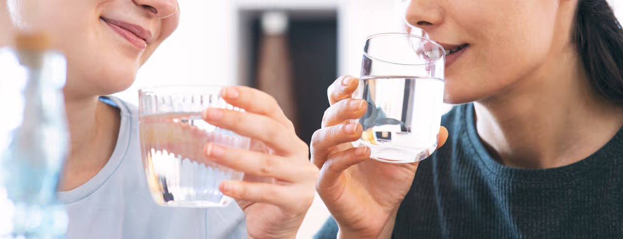 Two women drinking mineral water
