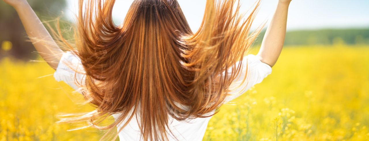 Frau, die die Haare in die Luft wirft