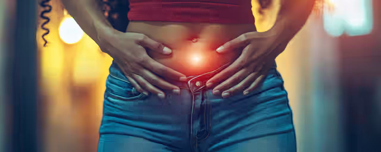 Eine Frau hält sich den Bauch, weil Sie Magen Darm Beschwerden hat