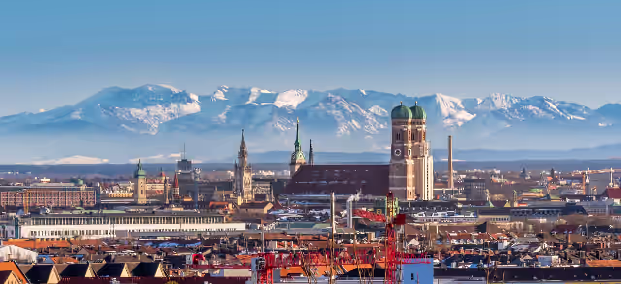 Skyline von München mit Alpenbergen im Hintergrund