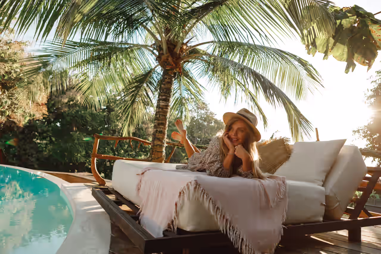 Eine Frau relaxt auf einer Liege am Pool