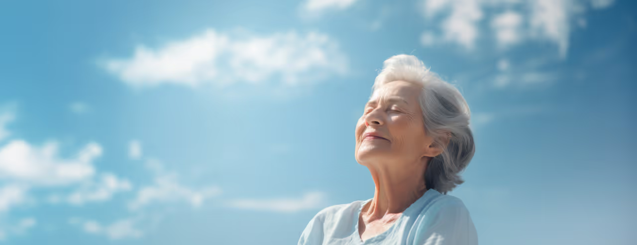 An elderly woman takes a deep breath freed from pain through meditation