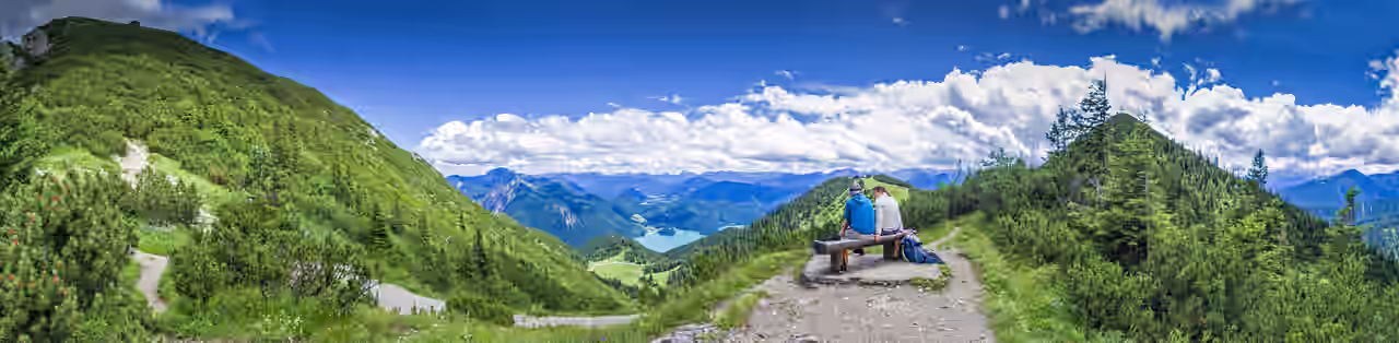 Ein Paar auf einer Bank mit Bergpanorama