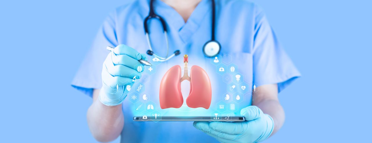 A doctor points to an image of the lungs